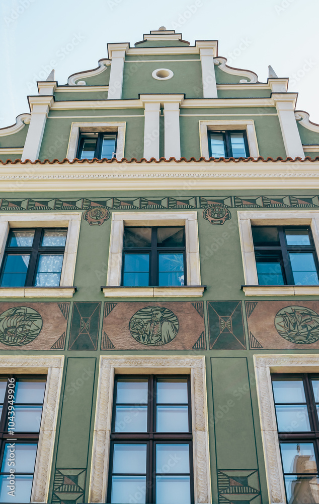 Colorful Historic Buildings and Houses on Stary Rynek Square in Poznań, Poland, with a Blue Sky and Mural Art