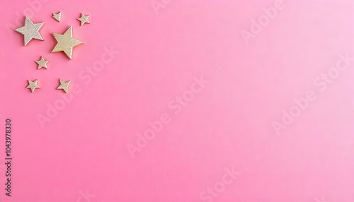 A collection of glittering gold stars of various sizes is arranged on a bright pink background, perfect for party decorations or artistic inspiration
