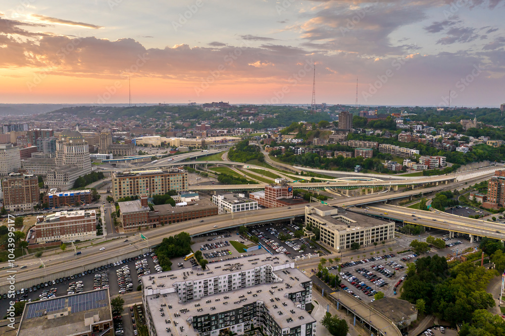 Fototapeta premium View from above of USA transportation infrastructure. Aerial view of American highway junction at sunset with fast driving vehicles in Cincinnati, Ohio