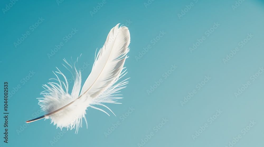A lone white feather drifting against a brilliant blue sky, captured in mid-air with crisp details A lone white feather drifting against a brilliant blue sky, captured in mid-air with crisp details