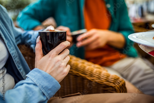 Couple drinking coffee. Close Up of the hands and coffee. photo