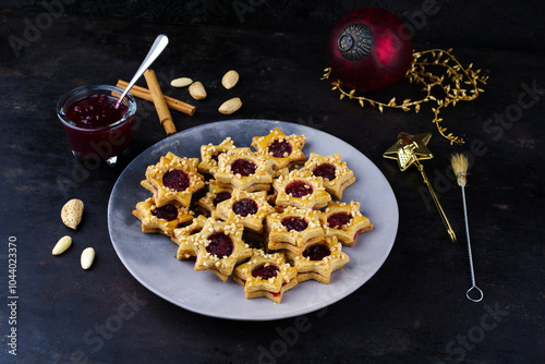 Homemade Christmas cookies biscuites Linzer augen, Spitzbuben with nuts and marmalade jam served as close-up on a design plate photo