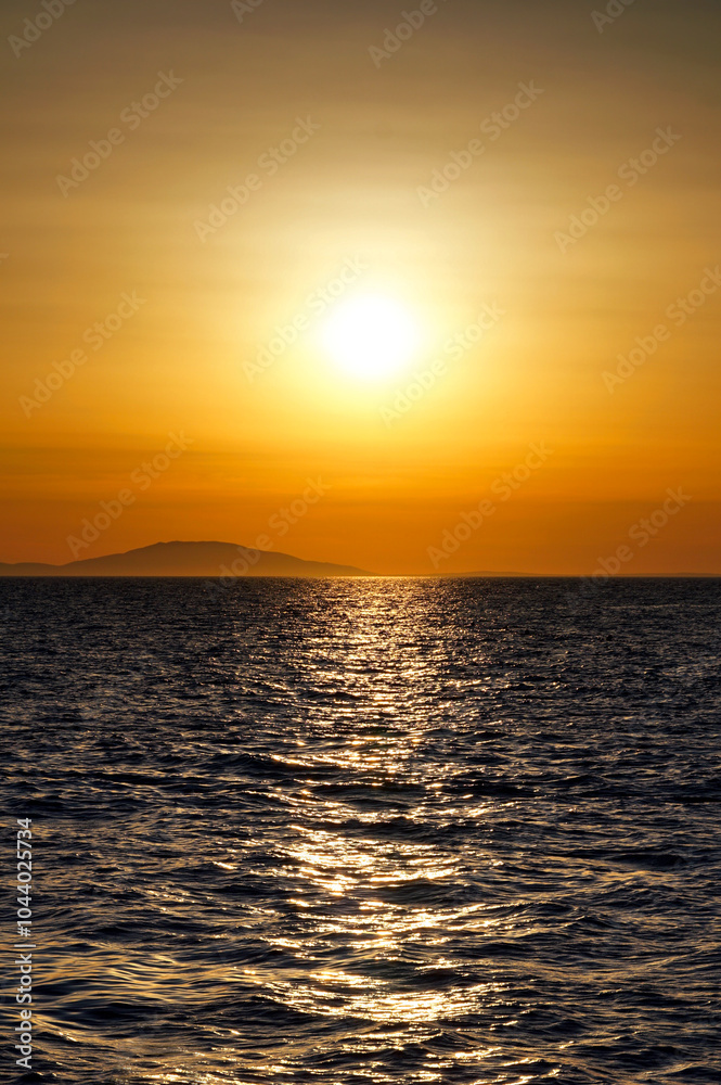 Beautiful shiny warm color sunset above wavy sea surface Beautiful shiny warm color sunset above wavy sea surface