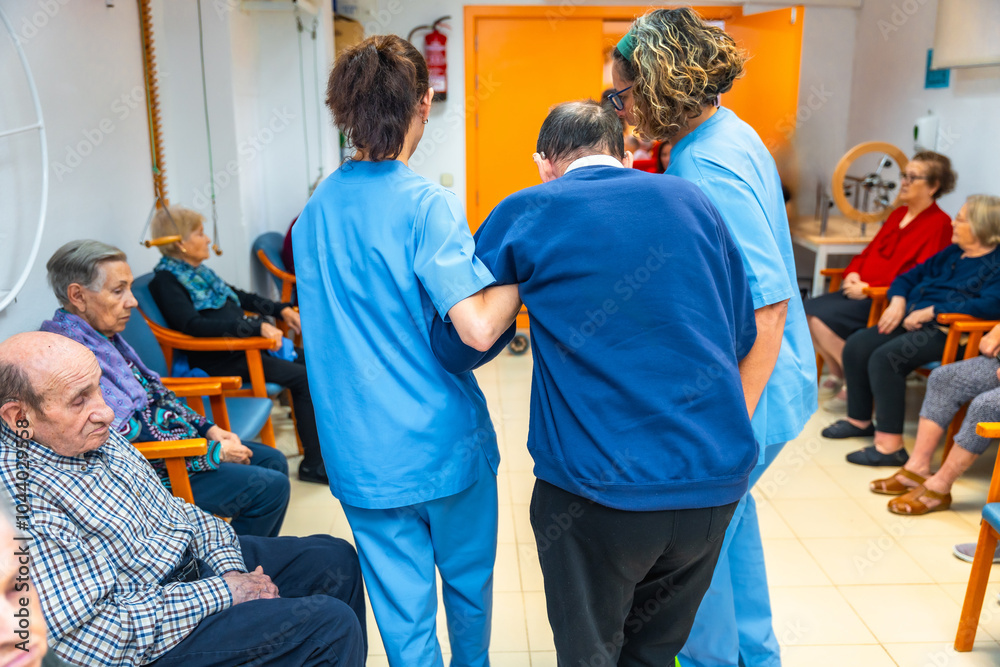 Nurses helping a man in the gym of a geriatrics Nurses helping a man in the gym of a geriatrics