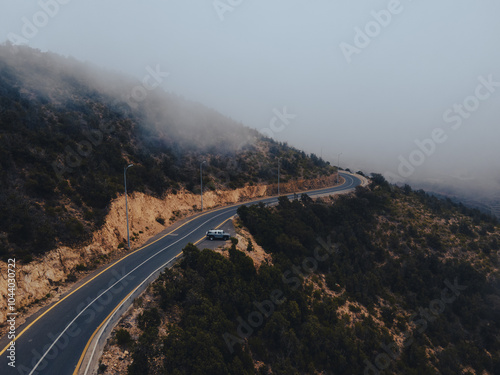 Aerial view of a countryside road surrounded by lush greenery in asir principality
