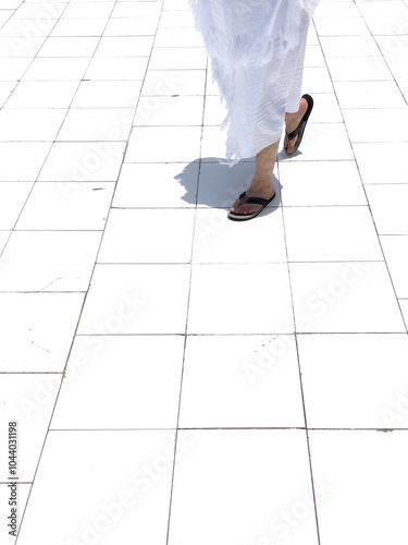 Cutout images of a person wearing slippers and white ihram clothing photo