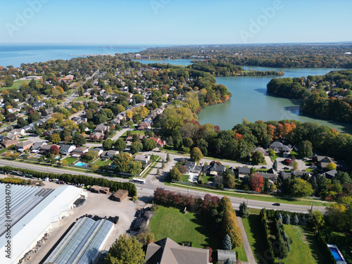 Aerial over Martindale Road and the Port Dalhousie area viewing west towards Lake Ontario over Martindale Pond in north St. Catharines, Ontario, Canada on a sunny Autumn day in October, 2024.