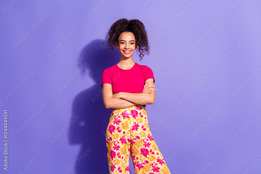 Photo of positive woman wear pink top arms folded empty space isolated violet color background Photo of positive woman wear pink top arms folded empty space isolated violet color background
