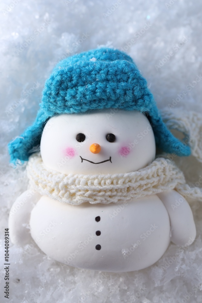 Fototapeta premium Cute decorative snowman on artificial snow, top view