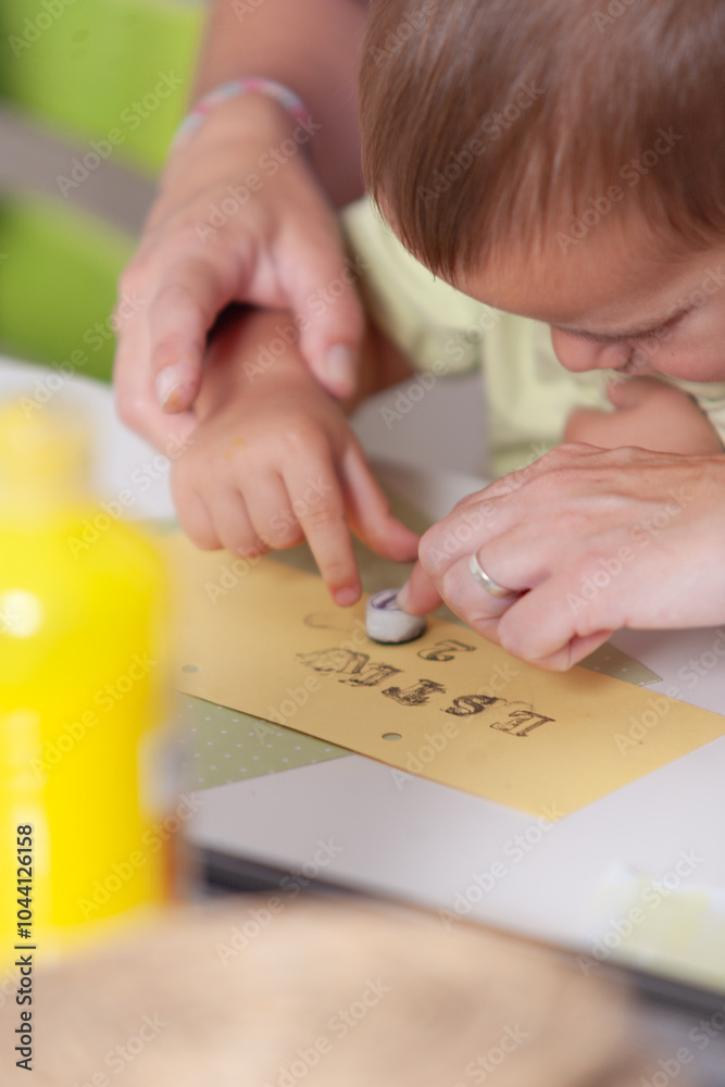 A child is making a card with a name on it A child is making a card with a name on it