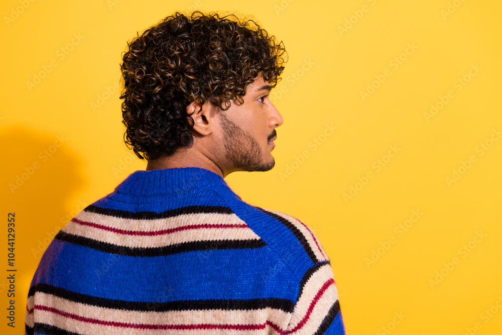 Fototapeta premium Photo portrait of attractive young man back view look empty space dressed stylish blue striped clothes isolated on yellow color background