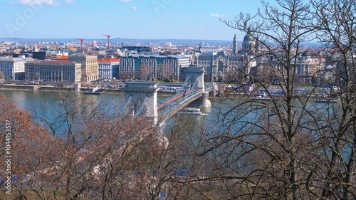 Cars on Secheni Bridge through Danube. A view of traffic on Secheni bridge to Budapest historic city center in the sun light. photo