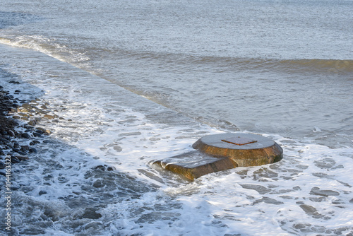 Concrete sewer pipes in the ocean leading to marine outfall into the sea potentially polluting the environment photo