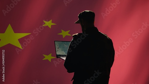 Chinese soldier using radar detecting ballistic missile attacks and conducting general space surveillance and satellite tracking. CCP agent using military laptop software preventing rockets, camera B photo