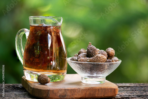 Malva nut or Scaphium macropodum Beaum dried fruits ,juice and jelly on natural background. photo