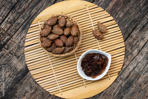 Malva nut or Scaphium macropodum Beaum dried fruits and jelly on an old wooden background.top view. photo