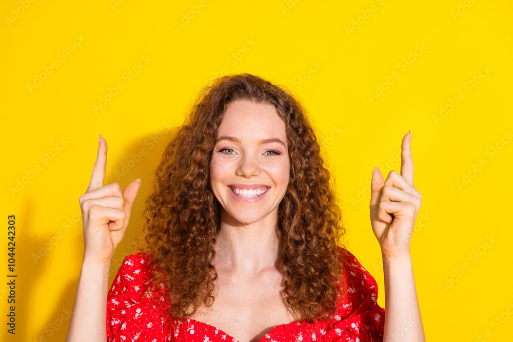 Photo portrait of attractive young woman point up empty space dressed stylish red clothes isolated on yellow color background Photo portrait of attractive young woman point up empty space dressed stylish red clothes isolated on yellow color background
