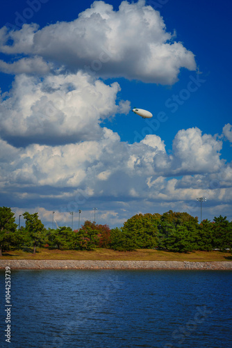 Oklahoma City Skyline with a blimp flying over the Oklahoma River into cumulous clouds in the Midwestern United States photo