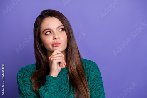 Portrait of pretty young girl look empty space ponder wear sweater isolated on violet color background