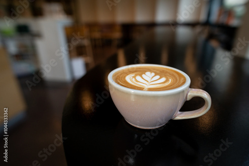 a cup of latte with a heart on it