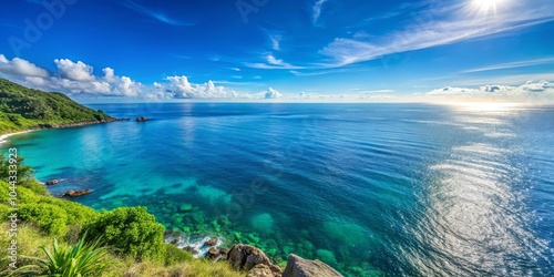 A Tranquil View of a Lush Coastal Landscape with Sparkling Blue Waters Under a Clear Sky