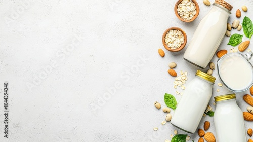 Top view of various vegan plant-based milk in glass bottles with almonds oats and soybeans on a rustic table photo