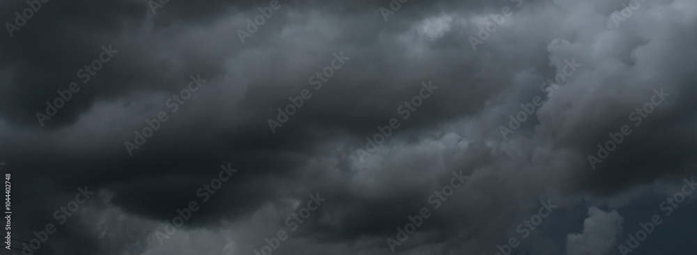 Banner Dramatic dark storm clouds black sky background. Dark thunderstorm clouds rainny season. Panorama Meteorology danger windstorm disasters climate. Dark cloudscape storm cloud with copy space. Banner Dramatic dark storm clouds black sky background. Dark thunderstorm clouds rainny season. Panorama Meteorology danger windstorm disasters climate. Dark cloudscape storm cloud with copy space.