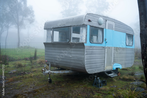 vintage Caravan camping at a campground off grid on a holiday in fog in the forest