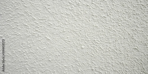 Rough textured white paint on light gray wall, close-up macro shot