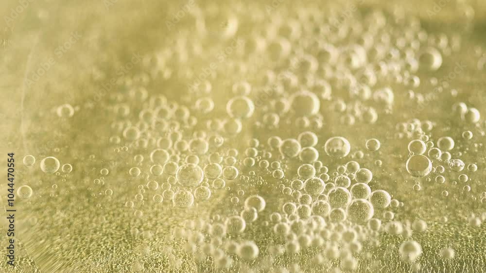 Bubble fluid. Oil water flow. Defocused golden color shiny air serum liquid swirl essential mix motion abstract art background. Bubble fluid. Oil water flow. Defocused golden color shiny air serum liquid swirl essential mix motion abstract art background.