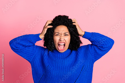 Portrait of crazy mad woman wear blue knitted stylish clothes isolated on pink color background