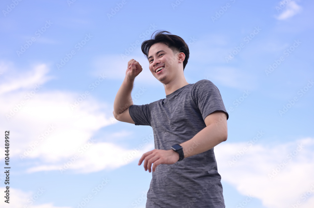 Smiling man enjoying a morning run in nature. Wellness and Healthy lifestyle concept Smiling man enjoying a morning run in nature. Wellness and Healthy lifestyle concept