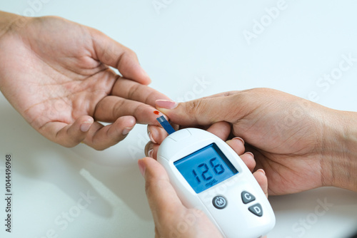 hand of people check diabetes and high blood glucose monitor with digital pressure gauge. Healthcare and Medical concept	 photo