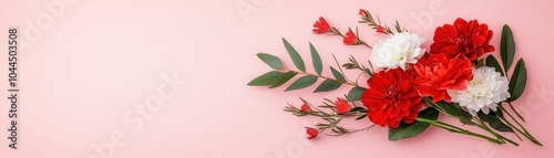 Vibrant bouquet of red and white flowers on a soft pink background.