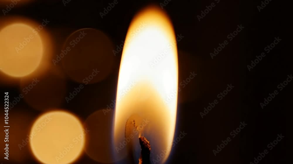 A close-up of a lit candle flame, highlighting its glow against a blurred background. A close-up of a lit candle flame, highlighting its glow against a blurred background.