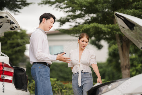 Car Trouble: A young couple experiencing a car breakdown on the road, looking worried and stressed as they discuss the situation. A sense of urgency and concern hangs in the air. 