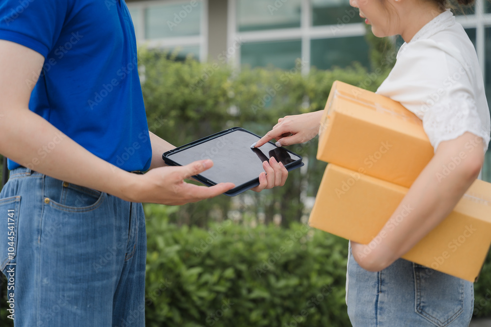 Delivery Confirmation: A delivery driver shows a customer the digital signature confirmation on a tablet, demonstrating the efficiency and security of modern delivery services. Delivery Confirmation: A delivery driver shows a customer the digital signature confirmation on a tablet, demonstrating the efficiency and security of modern delivery services.