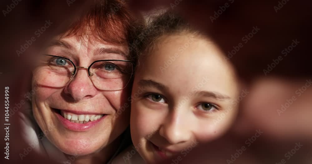 Affectionate happy old adult woman grandmother and cute adorable small kid granddaughter make heart shape hand gesture. Look at camera bonding laughing showing family love concept, closeup portrait Affectionate happy old adult woman grandmother and cute adorable small kid granddaughter make heart shape hand gesture. Look at camera bonding laughing showing family love concept, closeup portrait