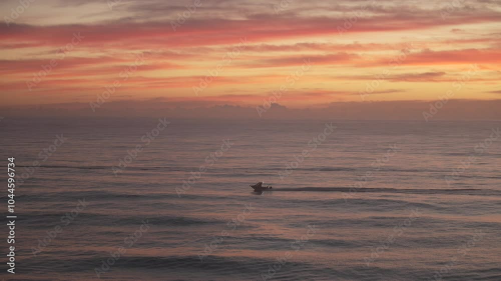 Small fishing boats motoring in the pacific ocean during sunrise at the Gold Coast, Australia. Small fishing boats motoring in the pacific ocean during sunrise at the Gold Coast, Australia.