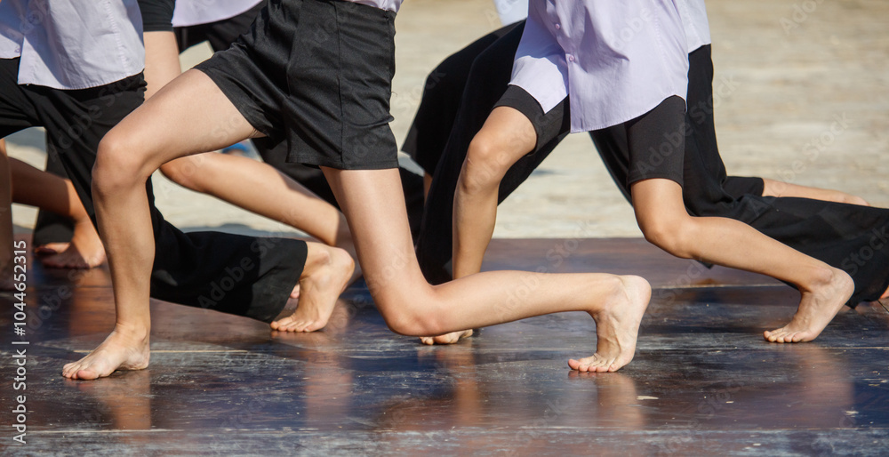 A group of people are dancing on a stage