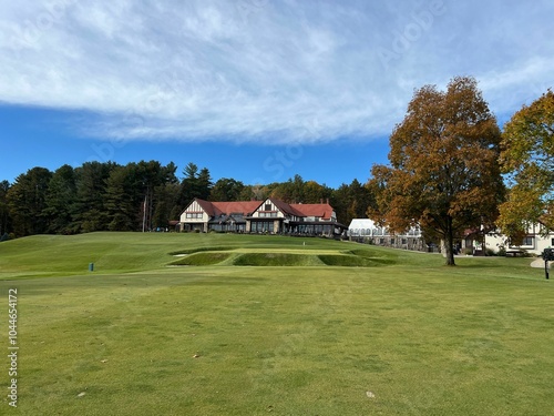 Scenic golf course with clubhouse and trees. photo