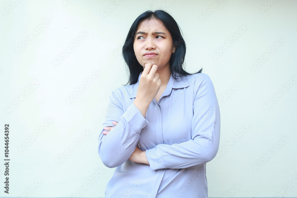 portrait of pensive beautiful asian woman looking away thinking something curious with hand touch her chin and folded arm wearing formal suit isolated over white background portrait of pensive beautiful asian woman looking away thinking something curious with hand touch her chin and folded arm wearing formal suit isolated over white background