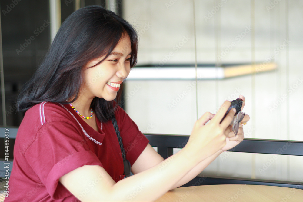 attractive and pretty asian woman excited playing online game using smartphone in cafe attractive and pretty asian woman excited playing online game using smartphone in cafe