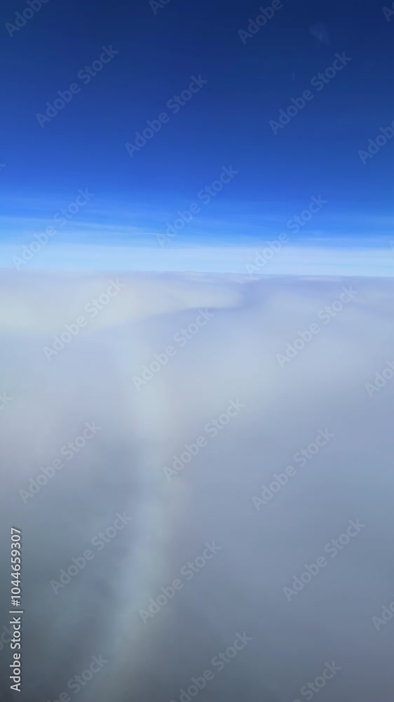 Airplane shadow creating circular rainbow on clouds Airplane shadow creating circular rainbow on clouds