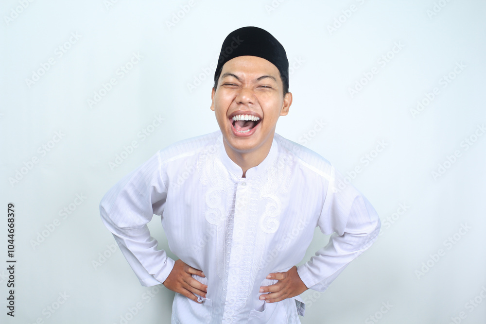 ecstatic asian muslim man laughing with hand on waist isolated on white background ecstatic asian muslim man laughing with hand on waist isolated on white background