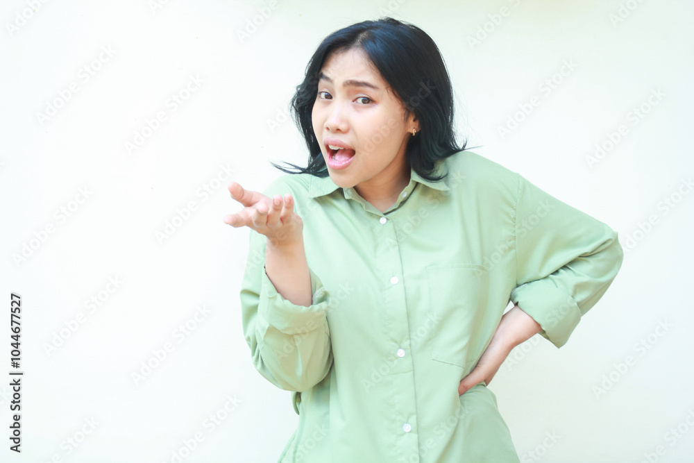 studio shot of angry asian woman standing over isolated white background with raising palms and hands on waist looking at camera show questioning gesture and mad expression studio shot of angry asian woman standing over isolated white background with raising palms and hands on waist looking at camera show questioning gesture and mad expression