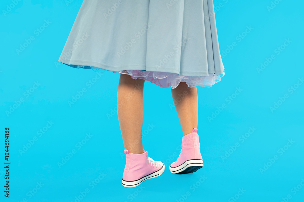 Elegant dance with a playful twist featuring stylish shoes against a vibrant blue backdrop at a joyful celebration Elegant dance with a playful twist featuring stylish shoes against a vibrant blue backdrop at a joyful celebration