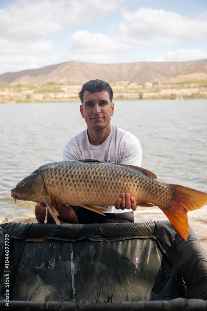 Young boy showing off a carp he just caught Young boy showing off a carp he just caught