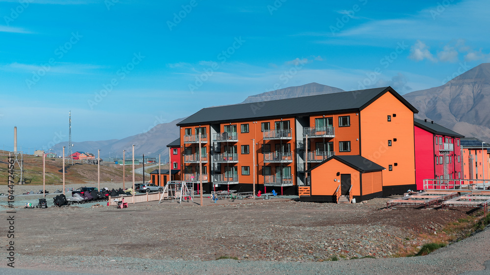 Colorful buildings in Longyearbyen Svalbard with mountains in the background on a clear day Colorful buildings in Longyearbyen Svalbard with mountains in the background on a clear day