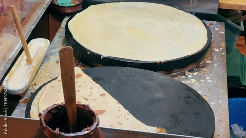 Chief cook and folds crepe. Crepe preparation on the street market. High quality 4k footage photo